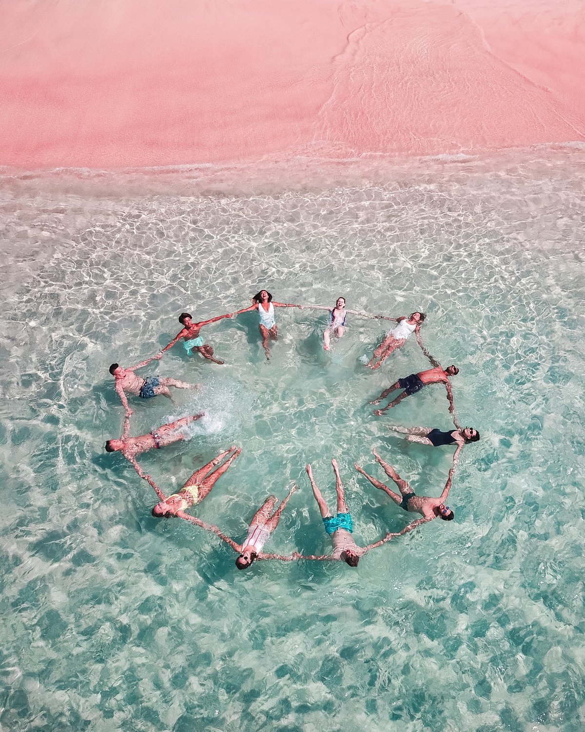 Photo of a group of people making a circle in the water