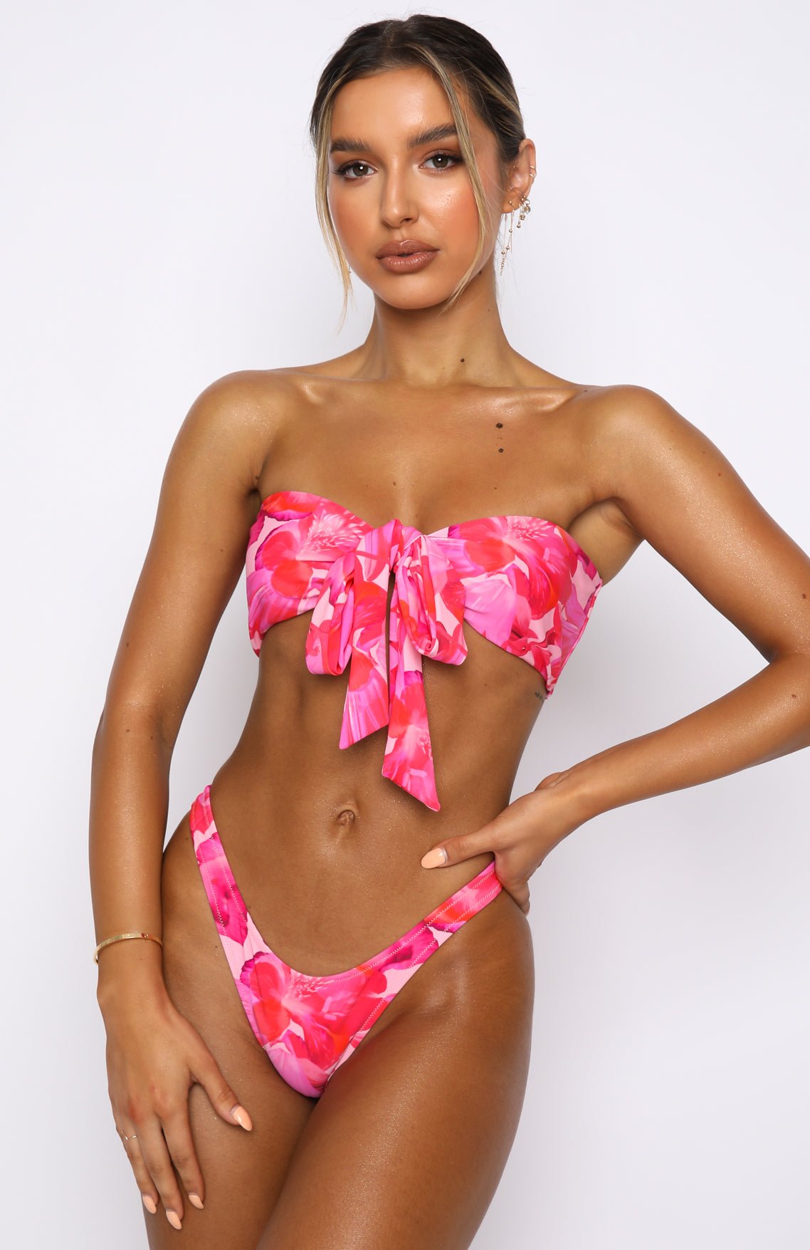 White Fox Girls Trip Bikini Top and Belmont Bottoms in Rose et Rouge Print, a pink floral bandeau bikini tied at the front