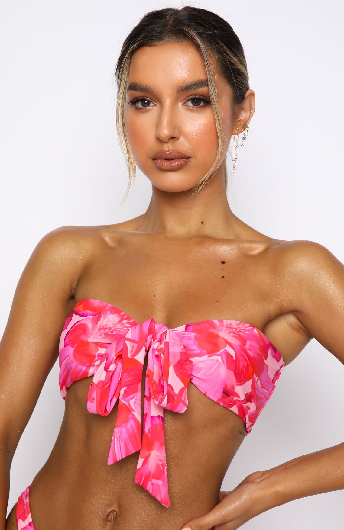 Close-up of the White Fox Girls Trip Bikini Top, a pink and red floral strapless bandeau tied in a bow at the front