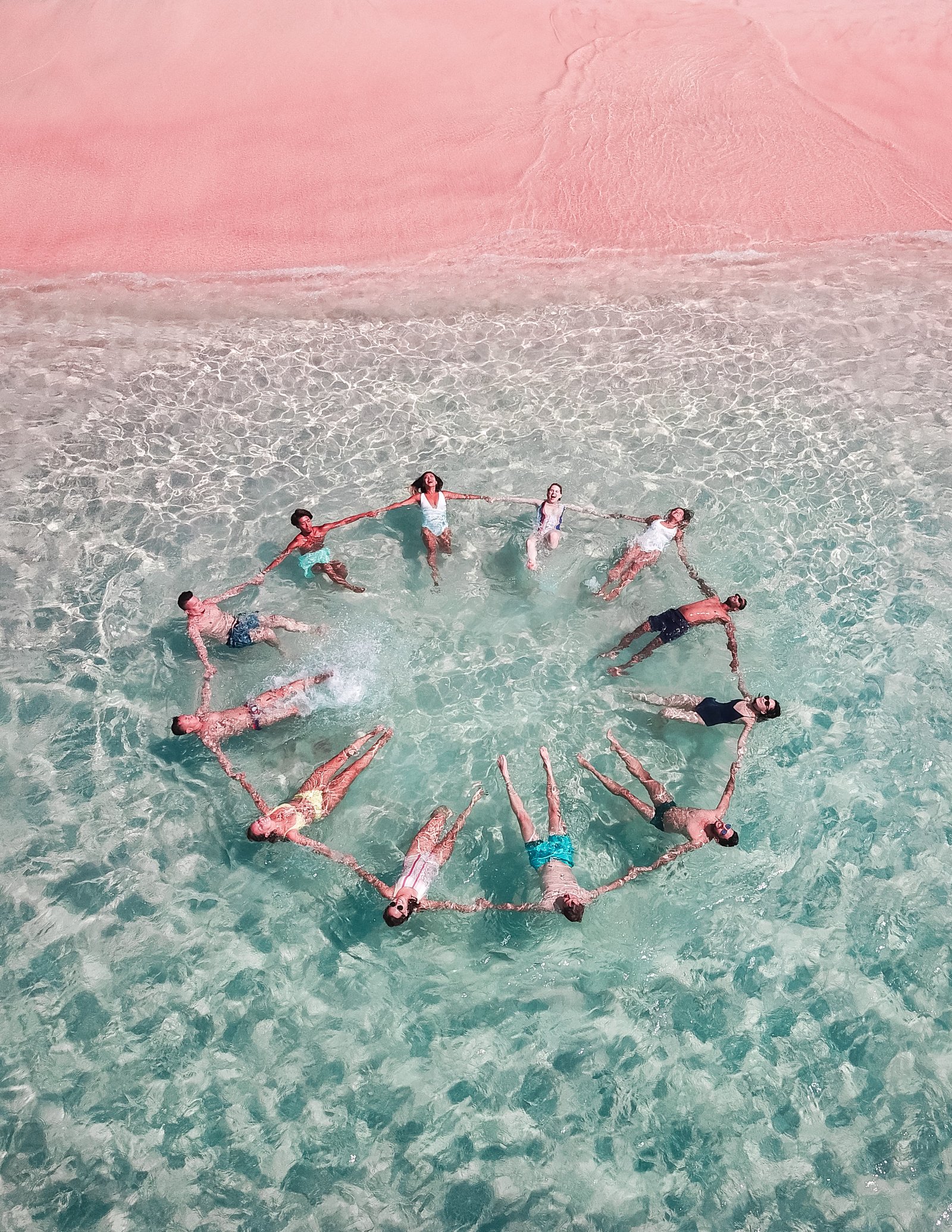 Photo of a group of people making a circle in the water