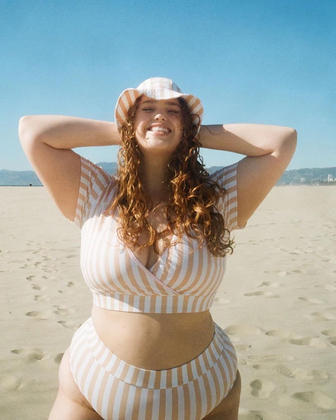 Bree Kish wearing a striped bikini by Alpine Butterfly Swim