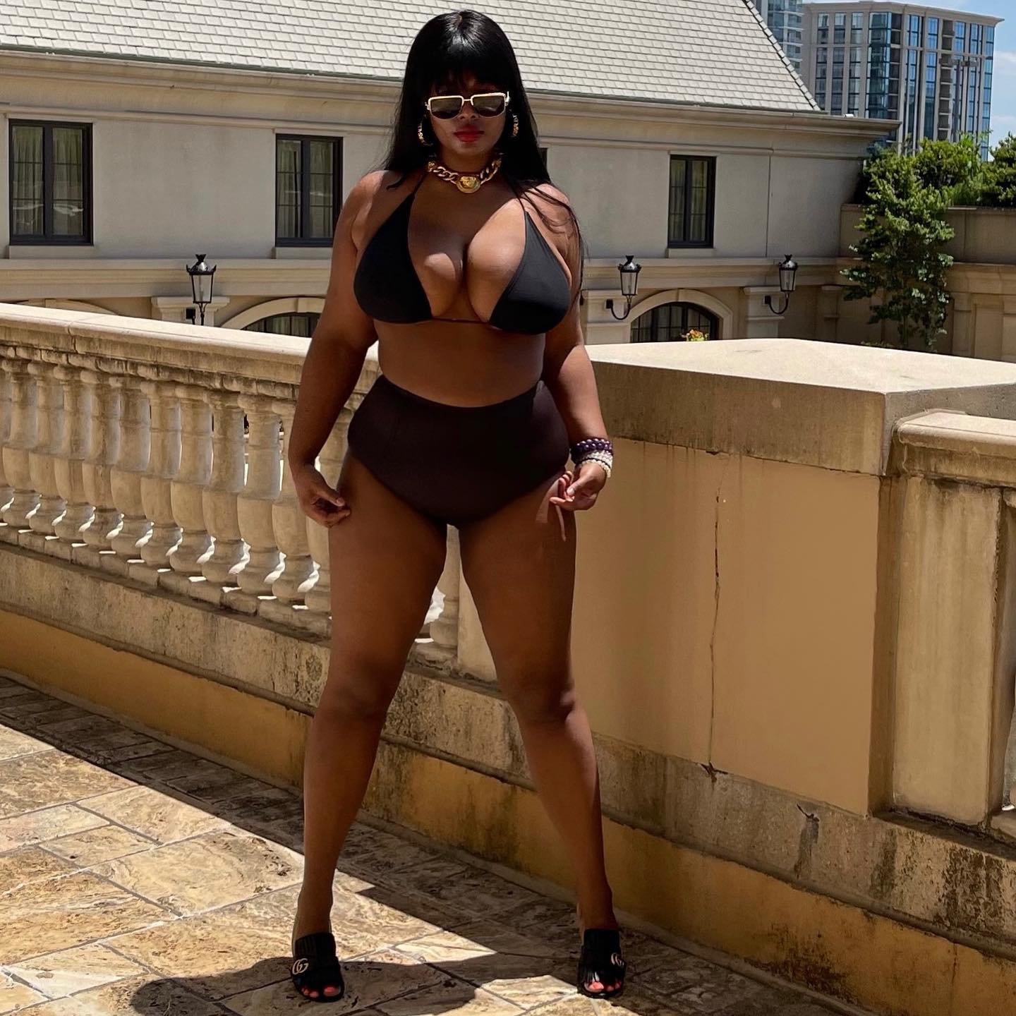 Precious Lee wearing a back bikini on a terrace