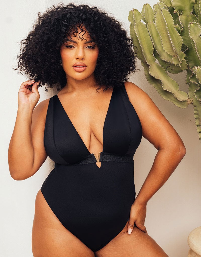 Curvy Kate Siren Seas Non-Wired Plunge Swimsuit in Black in Black with gold hardware, lifestyle editorial shot