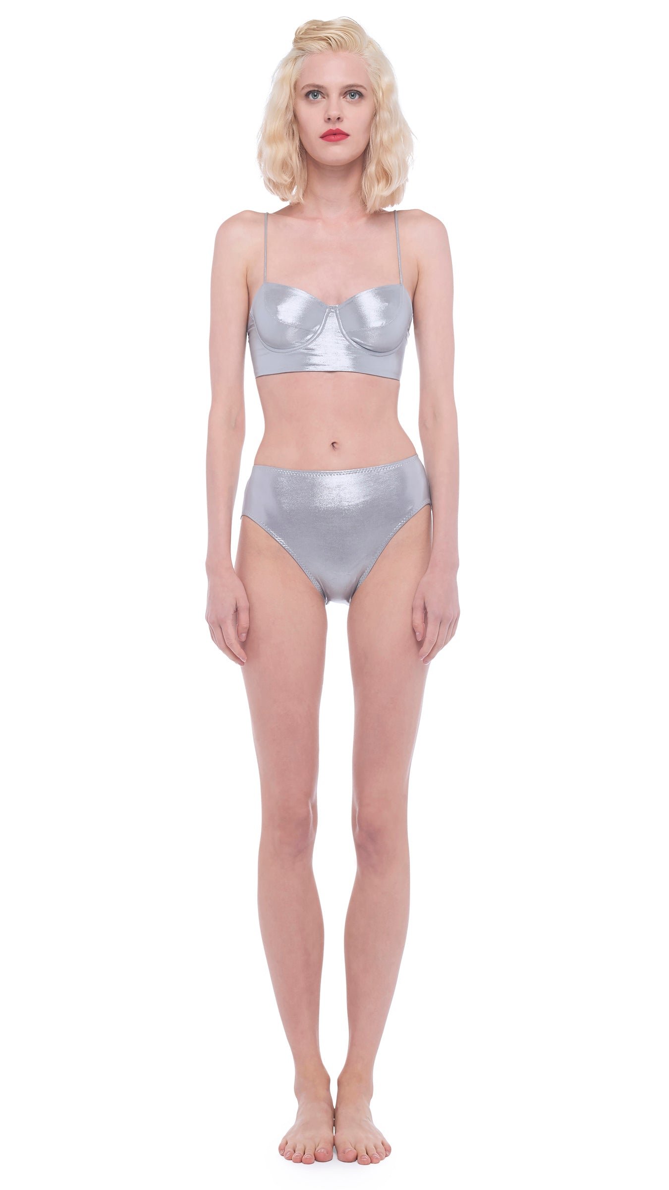 Model in a Norma Kamali silver metallic bikini with an underwire bra top and high-waisted brief