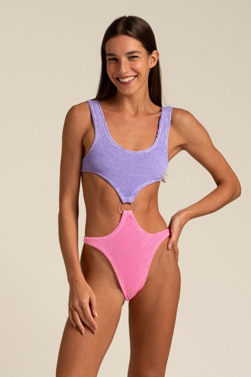 Reina Olga Augusta Swimsuit in hot pink and lilac, side O-ring cutouts and open back, editorial