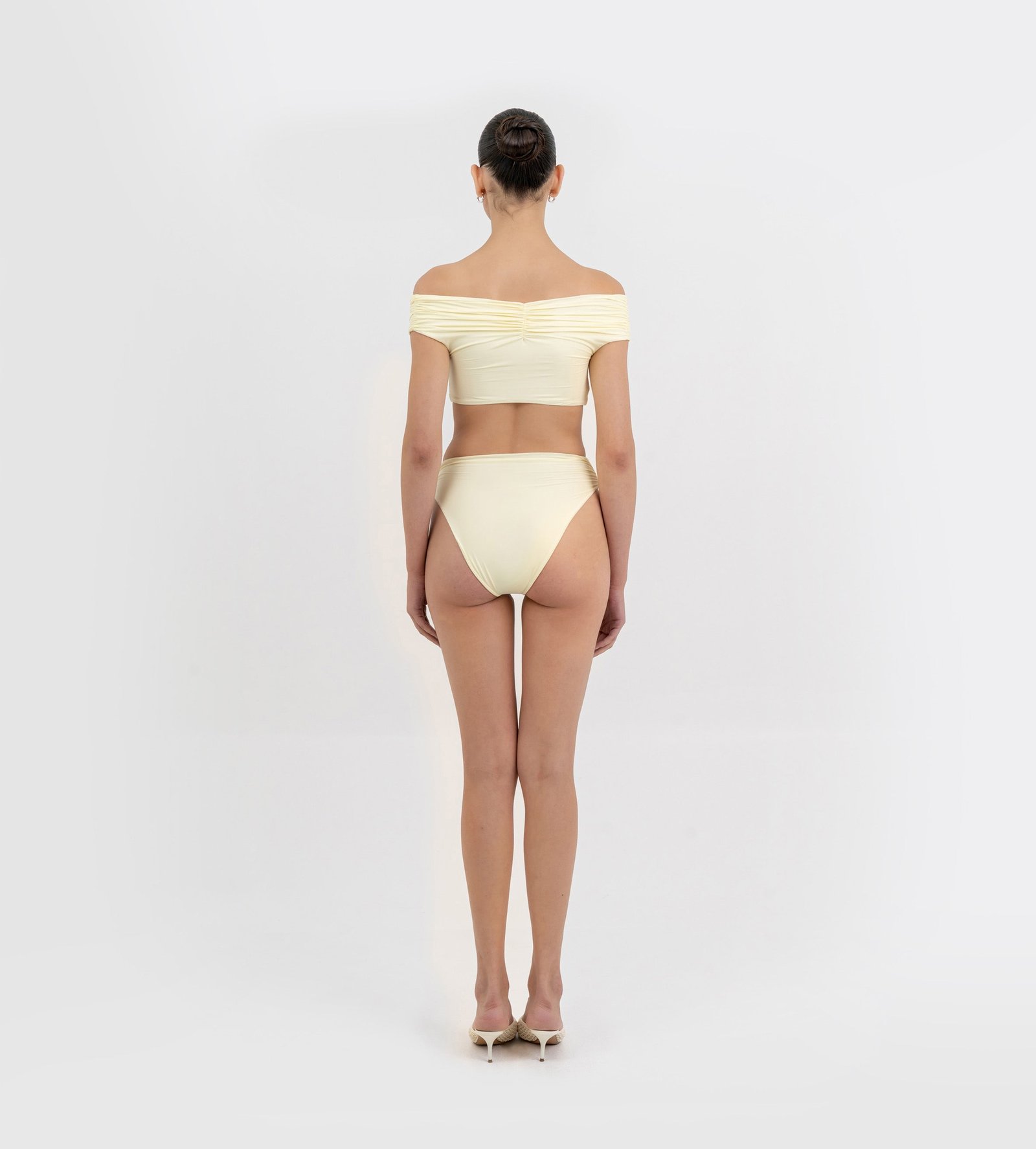 Back view of Maygel Coronel Rosy off-shoulder bikini in lemon yellow showing the draped top and high-cut bottom