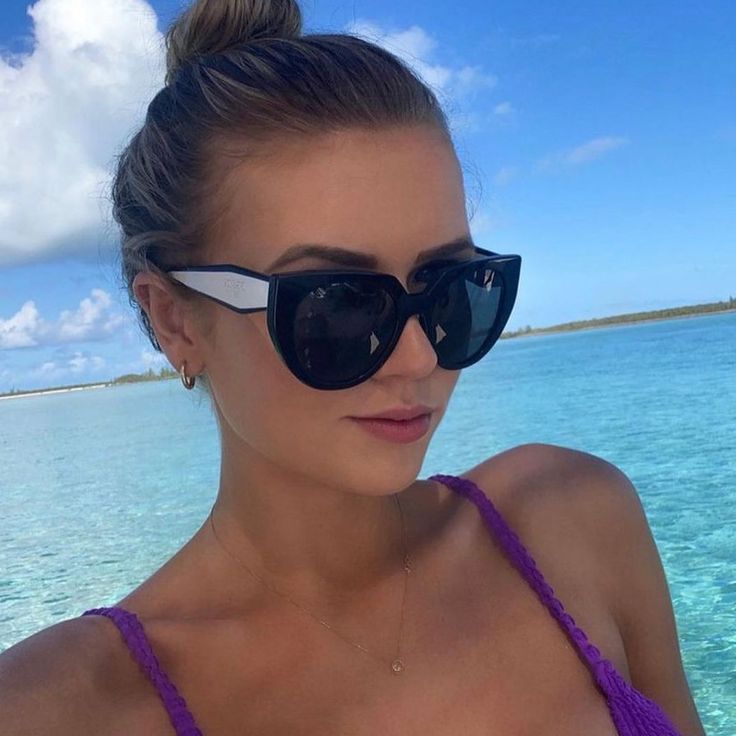 A woman wearing Prada sunglasses