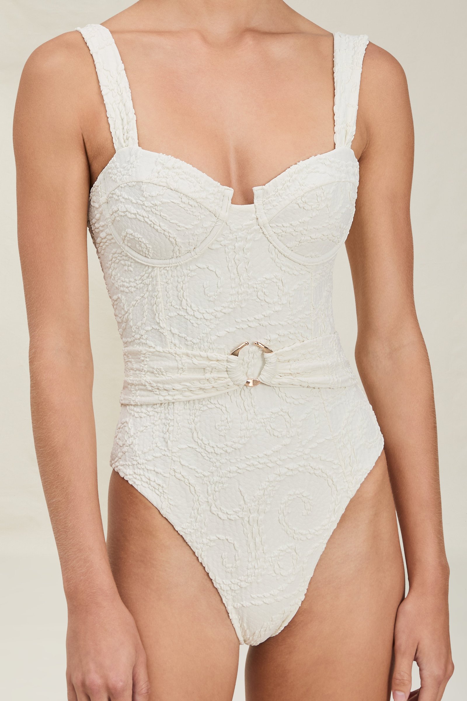 Tillie Full-Piece in ivory textured fabric, with underwired sweetheart cups and a ring-buckle belt, close-up on a model