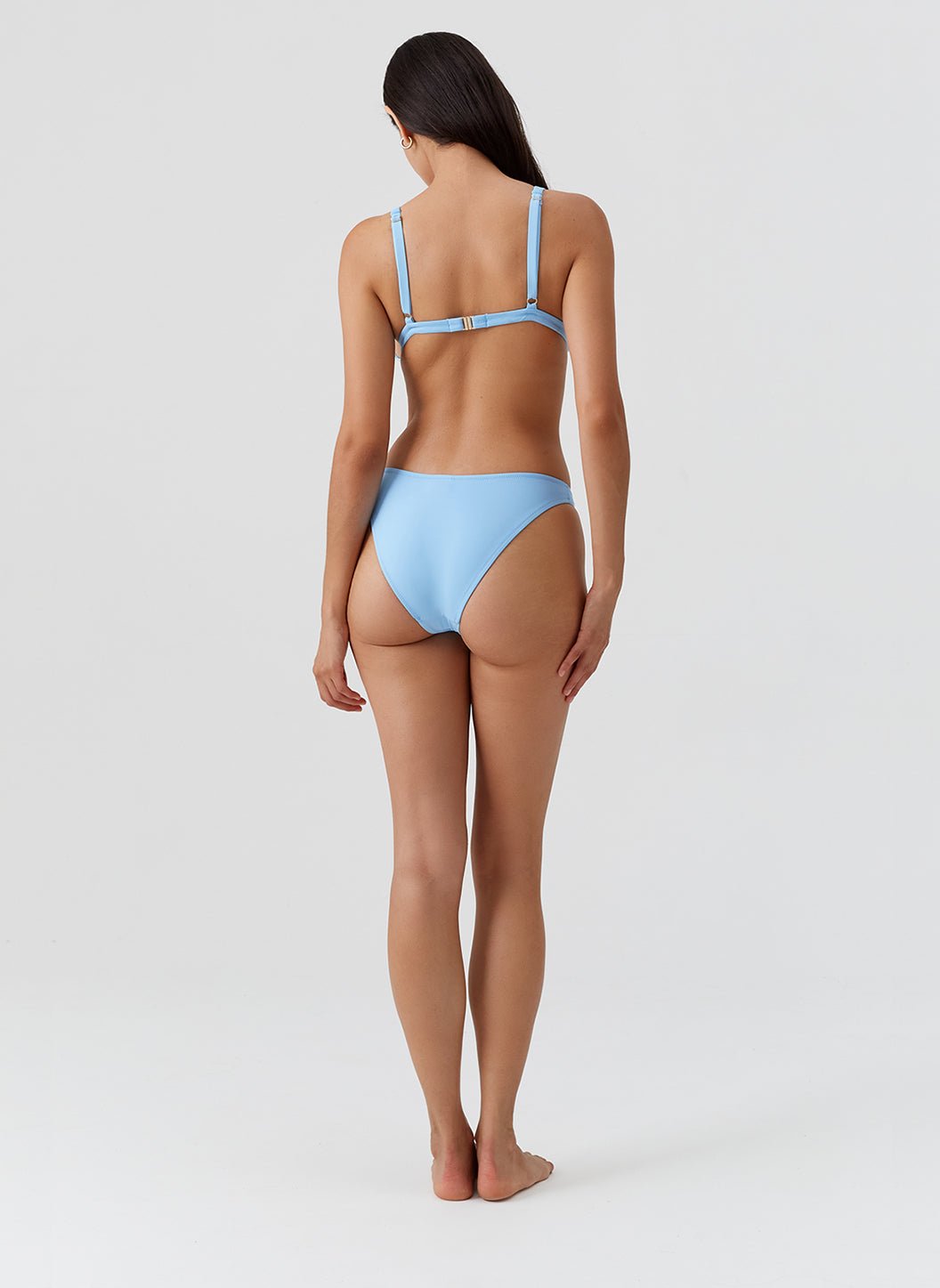 Melissa Odabash Oasis blue bikini back view showing clasp closure and high-cut bottom in studio