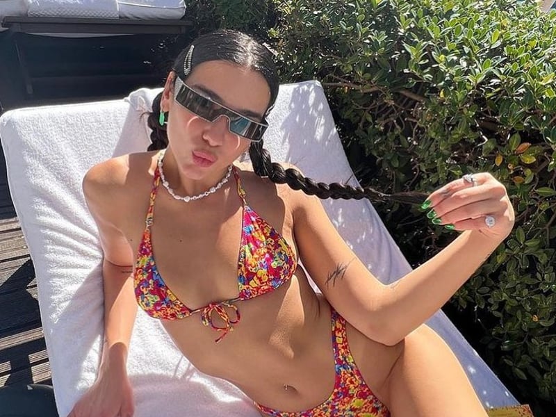 Dua Lipa on a sun lounger in a floral print bikini by Heavy Manners